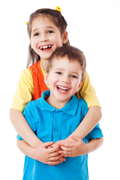 Two laughing little children standing together - Photo, Image
