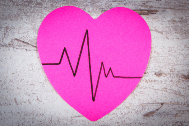 Heart of paper with cardiogram line on wooden background, medicine and healthcare concept - Φωτογραφία, εικόνα