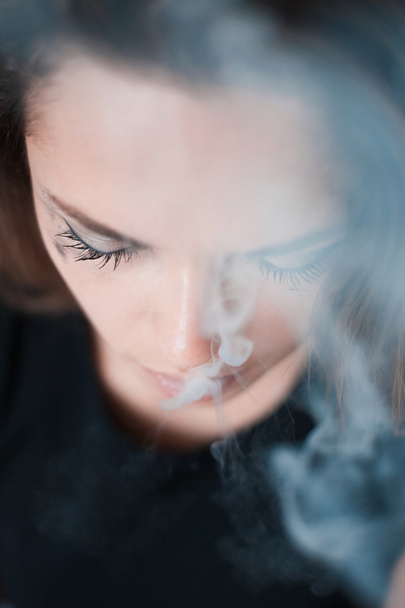the upset woman smokes - Фото, изображение