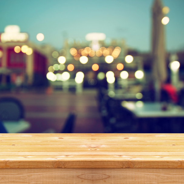 image of wooden table in front of abstract blurred background of city lights. - Fotoğraf, Görsel