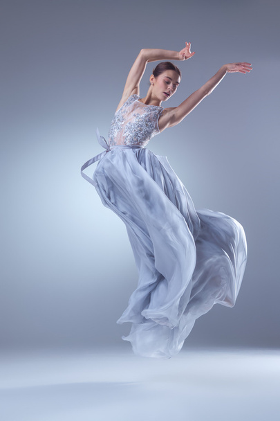 The beautiful ballerina dancing in blue long dress - Fotó, kép