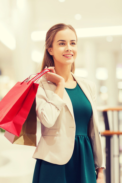 happy young woman with shopping bags in mall - Fotoğraf, Görsel