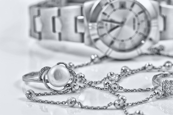 Silver ring and chain on the background of watches - Photo, image