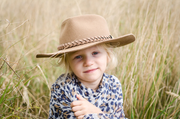 girl with hat in autumn meadow - Photo, Image