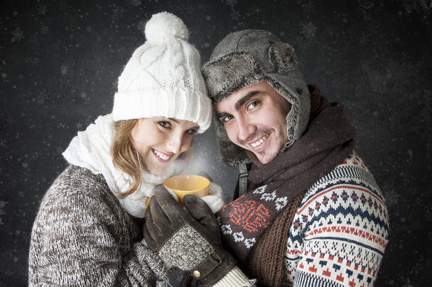 Happy young couple  with a cup of tea covering - Fotografie, Obrázek