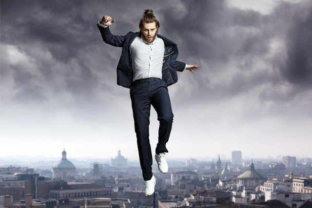 Fashion man jumping to the sky - Photo, Image
