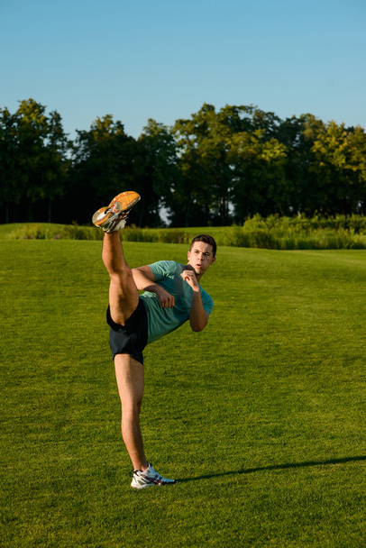 Kickboxer on a lawn. - Zdjęcie, obraz