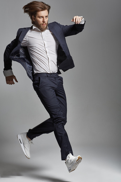 Elegant young guy jumping and dancing - Foto, Bild