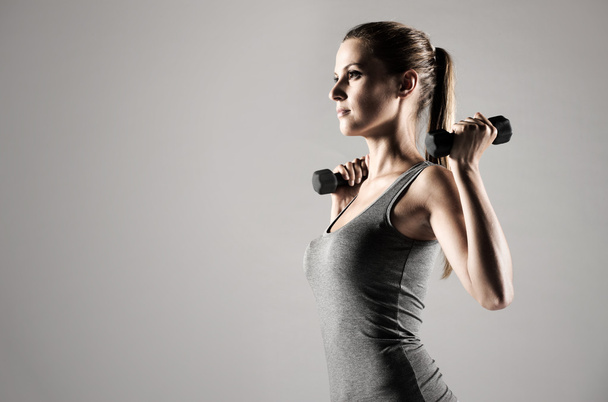 Woman lifting weights - Fotó, kép
