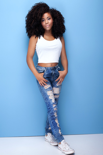 Young girl with afro posing on blue background. - Fotografie, Obrázek