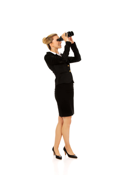 Young businesswoman with a binocular - Fotó, kép