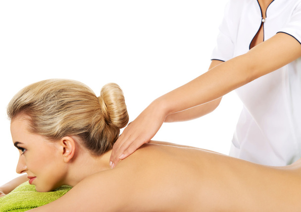 Young woman is being massaged. - Φωτογραφία, εικόνα