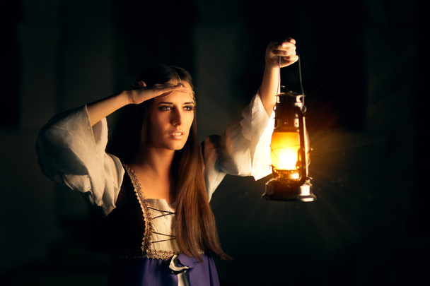 Beautiful Medieval Princess Holding Lantern Looking Outside - Foto, Imagen