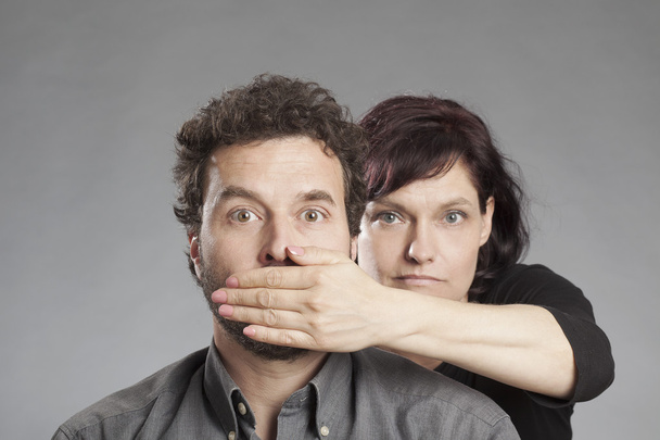 Mature couple woman covering man's mouth - Fotó, kép