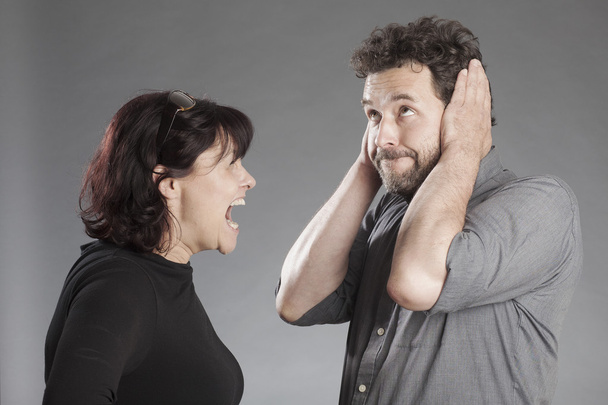 Mature couple quarreling woman shouting man covering ears - Foto, Imagen