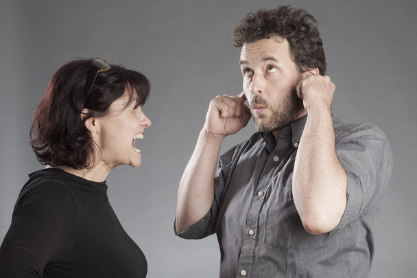 Mature couple quarreling woman shouting man covering ears - Photo, image