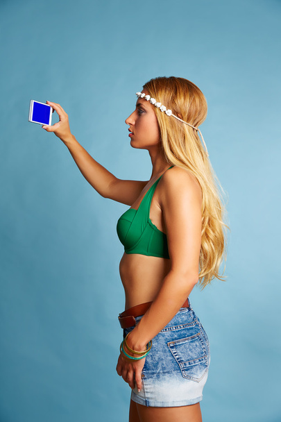 Blond long hair girl with jeans shorts selfie photo - 写真・画像
