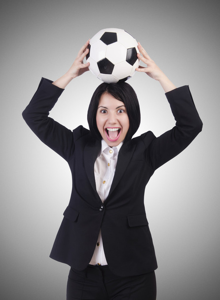 Businesswoman with ball on gray - Foto, afbeelding