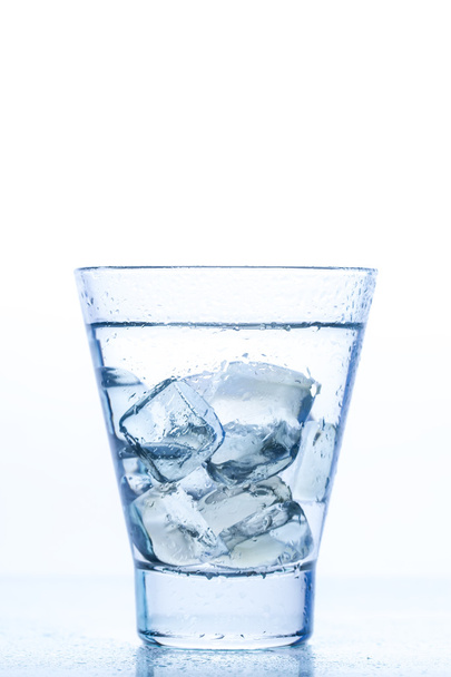 elegant glass with water and ice on a white background - Fotoğraf, Görsel
