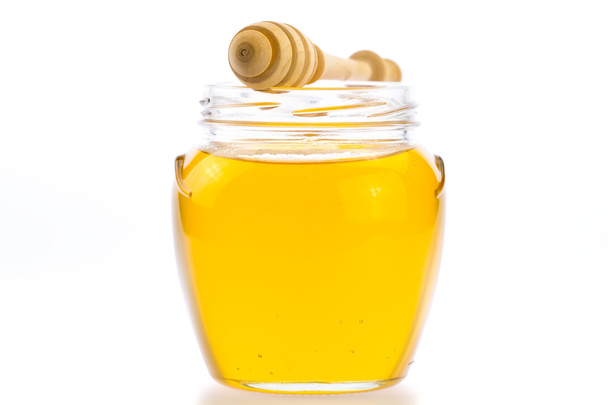 glass jar of fresh honey with drizzler isolated on white background - Φωτογραφία, εικόνα