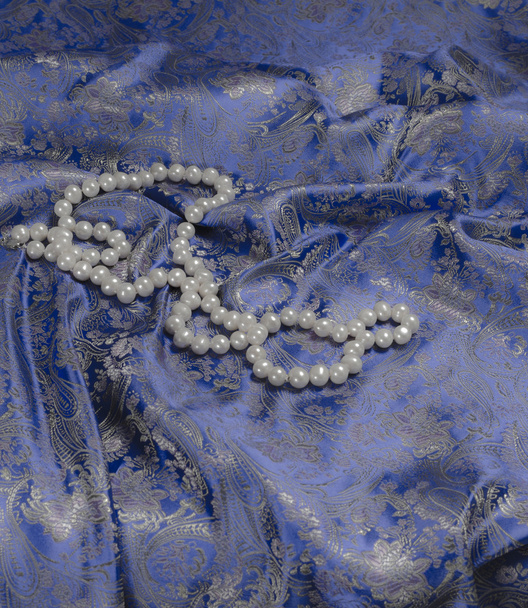Pearls a necklace on a silk fabric - Photo, Image