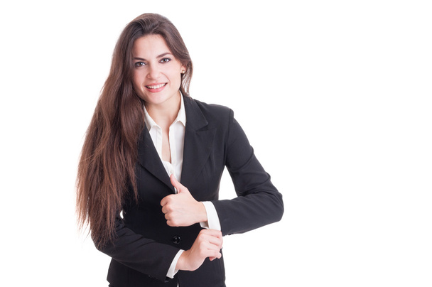 Long hair business woman adjusting suit sleeve - 写真・画像