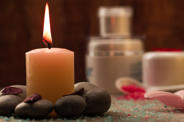 Spa composition with sea salt, candles, soap, shells, creams for face on wooden background. Aromatherapy. - Valokuva, kuva