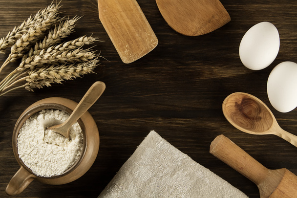 pot of flour, wheat ears, kitchen utensils on wooden background. homemade, menu, recipe, mock up - 写真・画像