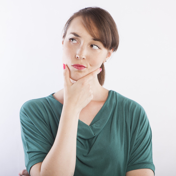 woman thinking with hand on chin - Photo, image