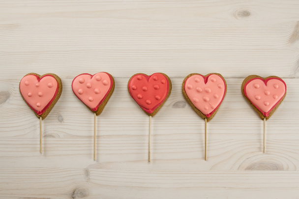 Delicious fresh cookies in the shape of a heart on a wooden background. - Фото, зображення