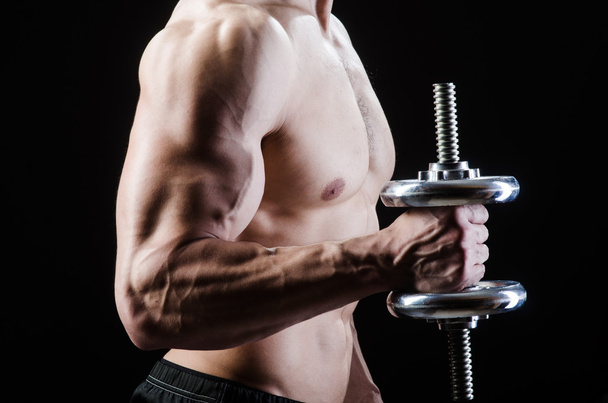 Muscular ripped bodybuilder with dumbbells - Фото, зображення
