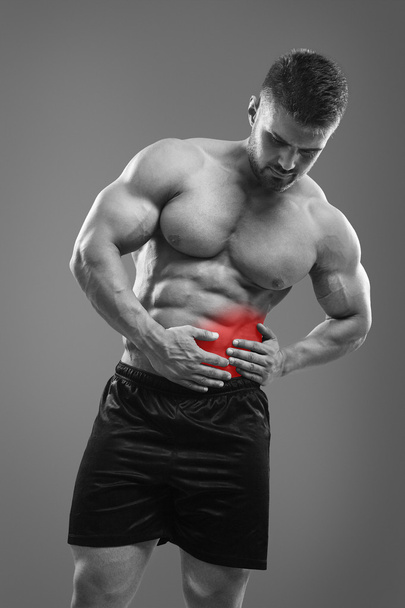 Bodybuilder with pain in left side of belly. - Valokuva, kuva