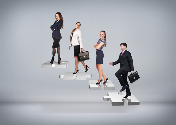 Business people stand on puzzle stairs - Photo, Image