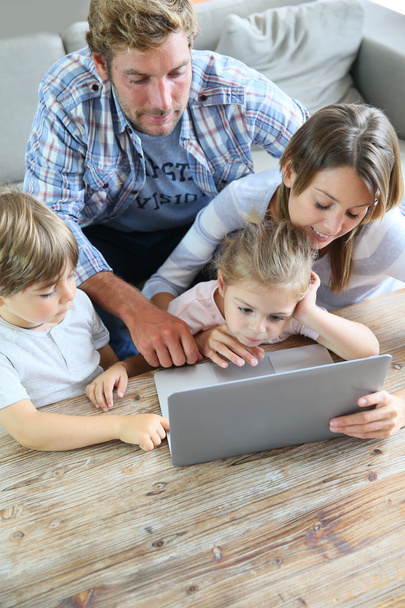 Parents with kids  using laptop - Photo, image