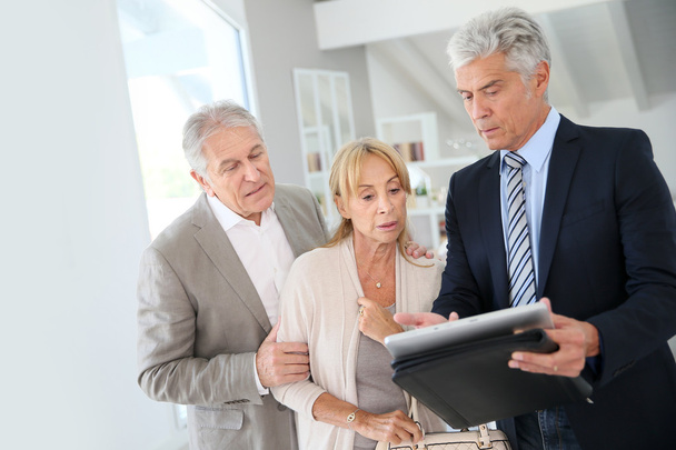 couple with real-estate agent visiting house - Photo, Image