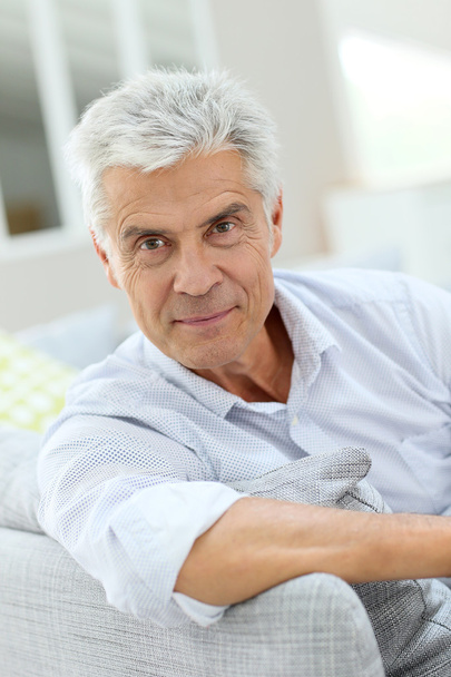 man relaxing on sofa at home - Photo, Image