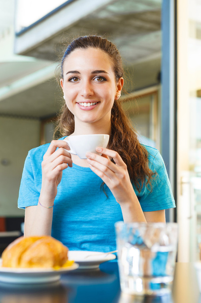 girl having a coffee break with cappuccino - Photo, Image