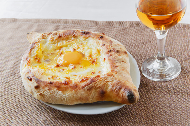 khachapuri with cheese and egg on a plate - Photo, Image
