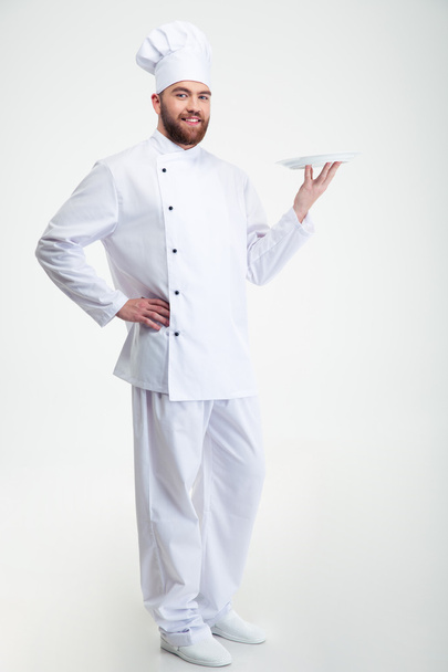 Portrait of a happy male chef cook standing with plate - Foto, Imagem