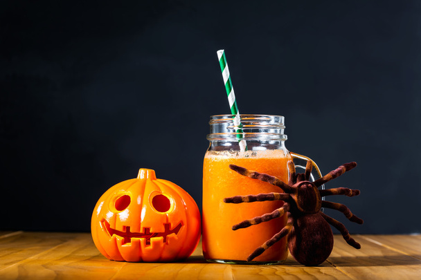 Halloween pumpkin with carrot juice in masons jar - 写真・画像