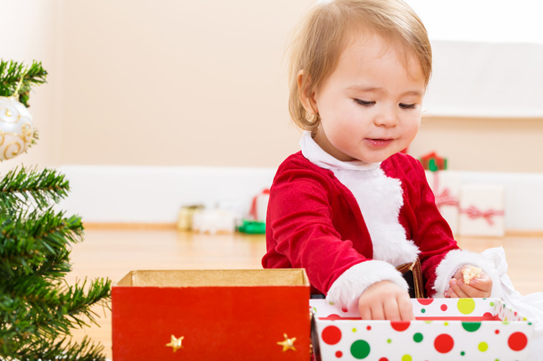 Little girl playing with her Christmas presents - 写真・画像
