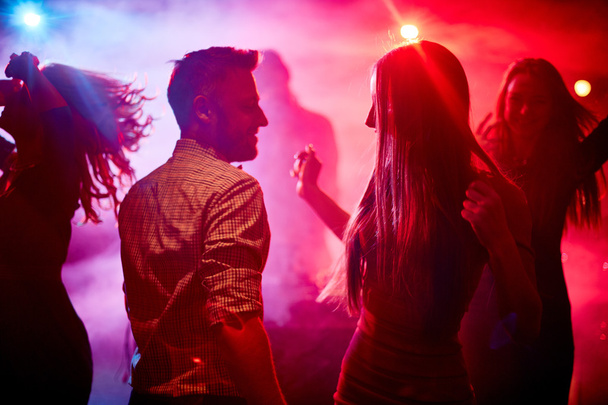 couple and their friends in disco club - Photo, Image