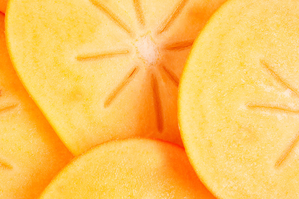 Cuted persimmon on few pieces - Zdjęcie, obraz