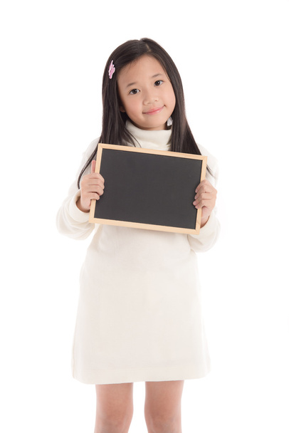Cute asian girl in white turtleneck dress holding blackboard - Foto, afbeelding