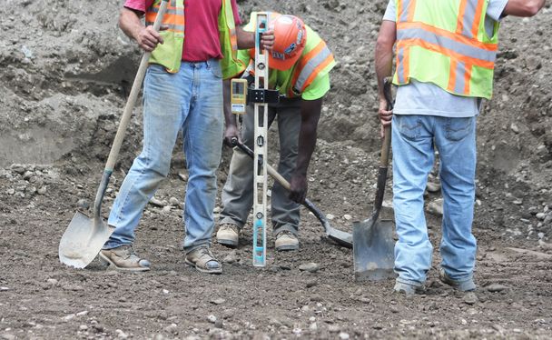 Workmen taking a measurement - Photo, Image