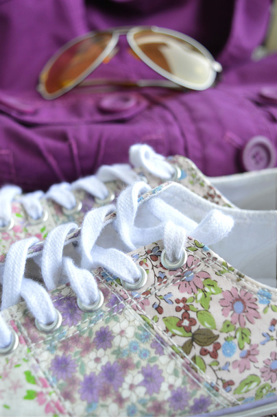 Beautiful womanly shoes with flowers, purple jacket and sunglasses on the background. Bright autumn look - Photo, Image