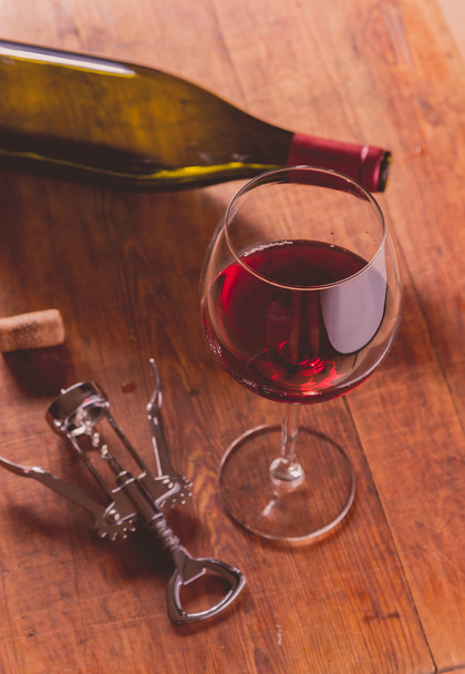 Red wine against wooden background - Fotó, kép