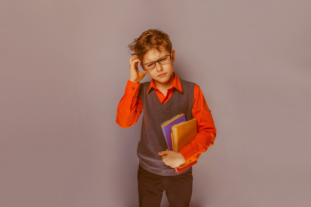 European-looking boy  of ten years in glasses thinking intently - Photo, Image