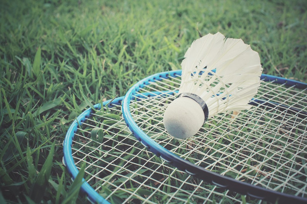Shuttlecocks with badminton racket on green grass - Photo, Image