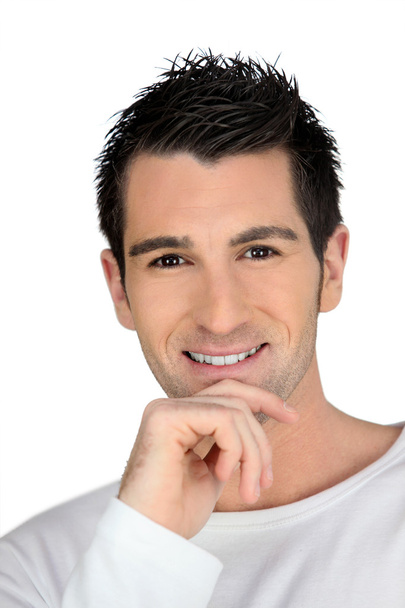 Man smiling with his hand on his chin - Photo, image
